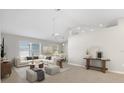 Bright living room featuring neutral colors, a fan, and plenty of space for furniture at 3413 5Th W Dr, Palmetto, FL 34221