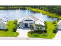 Stunning home with pristine landscaping, lake view, and a patterned driveway at 3811 158Th Avenue E Cir, Parrish, FL 34219