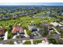 Aerial view of home on golf course with pool, lush landscaping, and solar panels at 4104 Las Palmas Way, Sarasota, FL 34238
