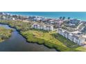 Beautiful aerial view of condos surrounded by lush landscape and sparkling shoreline at 4600 Gulf Of Mexico Dr # 201, Longboat Key, FL 34228