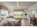Cozy living room with coffered ceiling, large windows, and stunning water views at 4600 Gulf Of Mexico Dr # 201, Longboat Key, FL 34228