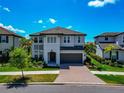 Charming two-story home with a two-car garage, lovely landscaping, and a brick paved driveway at 4881 Antrim Dr, Sarasota, FL 34240