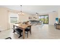 Open-concept living and dining area with large windows and tile flooring at 5406 Coral Reef Way, Lakewood Ranch, FL 34211