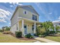 Charming two-story home with a welcoming front porch, colorful landscaping, and a beautifully maintained lawn at 5532 River Sound Ter, Bradenton, FL 34208