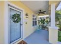 View of front door and front porch with a seating area and potted plants at 5532 River Sound Ter, Bradenton, FL 34208