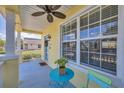 View of covered front porch with seating area and ceiling fan at 5532 River Sound Ter, Bradenton, FL 34208
