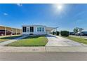 Well maintained single story home with a driveway and manicured lawn at 5619 Bayshore Rd # 152, Palmetto, FL 34221