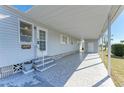 Single story home with a covered carport, entryway, and landscaped yard at 5619 Bayshore Rd # 152, Palmetto, FL 34221
