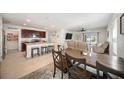 Open-concept kitchen featuring stainless steel appliances, granite countertops, a pantry, and an island with barstool seating at 5868 Calla Lilly Dr, Sarasota, FL 34232