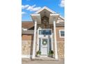 Close up of the home's front entrance with stone accents and a charming wreath at 5949 225Th E St, Bradenton, FL 34211