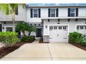 A lovely townhouse with a one-car garage, complemented by lush, well-maintained landscaping at 6473 Baytown Dr, Sarasota, FL 34240