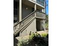 Exterior of condo with a wooden staircase and a peek at the covered parking area at 767 Pine Run Dr, Osprey, FL 34229