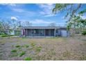 Exterior view of the house featuring a covered porch, neutral color palette and a well-maintained yard at 8555 Heron Lagoon Cir, Sarasota, FL 34242