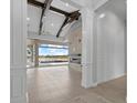 Bright, open-concept living area with beamed ceilings, modern fireplace and sliding doors to the patio at 9241 Starry Night Ave, Sarasota, FL 34241