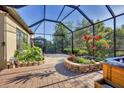 Screened-in patio featuring brick planters and view of the surrounding outdoor area at 9914 Craftsman Park Way, Palmetto, FL 34221