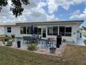 Outdoor patio area with a dining table, chairs, grill, and landscaping at 1007 Pussywillow Ln, Bradenton, FL 34208