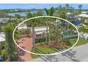 Aerial view of the property showcasing the home, pool, and waterfront location at 107 Nippino W Trl, Nokomis, FL 34275