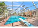 Inviting pool area with diving board and screened enclosure at 107 Nippino W Trl, Nokomis, FL 34275