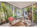 Cozy screened porch with tiled floor, perfect for outdoor relaxation at 107 Nippino W Trl, Nokomis, FL 34275