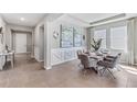 Inviting dining room with stylish decor, elegant lighting and an open floor plan at 10713 Tippecanoe Pl, Parrish, FL 34219