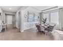 Formal dining area boasting stylish decor, large windows, elegant lighting, and comfortable seating at 10717 Tippecanoe Pl, Parrish, FL 34219