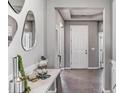 Elegant home entryway featuring neutral colors, tile flooring, and a decorative console table with accessories at 10717 Tippecanoe Pl, Parrish, FL 34219