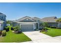 Lovely single-story home showcasing a two-car garage, landscaped front yard, and a serene setting at 11021 Blue Magnolia Ln, Parrish, FL 34219