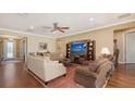 Cozy living room featuring hardwood floors, comfortable seating, and recessed lighting at 11176 Roseate Ct, Sarasota, FL 34238