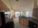 Bright kitchen open to the living room, featuring tile floors and stainless appliances at 11811 53Rd Ct E, Parrish, FL 34219
