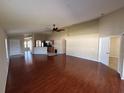 Spacious living room featuring hardwood floors, an open layout, and modern ceiling fan at 11811 53Rd Ct E, Parrish, FL 34219