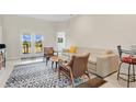 Bright living area features a comfortable sofa, stylish chairs, and serene backyard views through double doors at 16139 69Th E Ln, Parrish, FL 34219