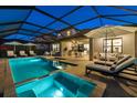 Inviting screened-in pool area with spa, lounge chairs, and outdoor seating, perfect for relaxation and entertaining at 16626 Paynes Mill Dr, Lakewood Ranch, FL 34211