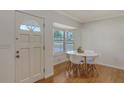 Bright breakfast nook with a white table, modern chairs, hardwood floors, and a window with light-filtering blinds at 2220 Palm Ter, Sarasota, FL 34231