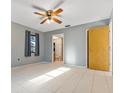 Spacious bedroom with tile flooring, ceiling fan, closet and en-suite bathroom access at 2272 Palomar St, North Port, FL 34287