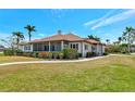 Charming home features a screened porch, manicured lawn, and beautiful landscaping at 2305 Riverview Blvd, Bradenton, FL 34205