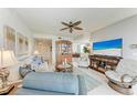 Inviting living room with comfortable seating, ceiling fan, and access to balcony at 23261 Banbury Way # 501, Venice, FL 34293