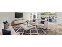 Bright living room with neutral furniture, a cozy rug, and sliding doors to the lanai and waterfront view at 2435 E Del Webb Blvd, Sun City Center, FL 33573