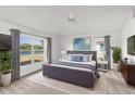 Spacious main bedroom with a calming lake view, a ceiling fan, and a soothing color palette at 2435 E Del Webb Blvd, Sun City Center, FL 33573