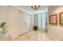 Classic condo entryway with a decorative door, marble floors, and elegant wall decor at 2450 Harbourside Dr # 251, Longboat Key, FL 34228