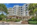 Beautifully landscaped exterior featuring a white building with manicured gardens and water feature at 2450 Harbourside Dr # 251, Longboat Key, FL 34228