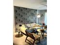 Inviting living room with stylish wallpaper, comfortable seating, and modern decor at 2601 Pine Lake Ter # B, Sarasota, FL 34237