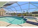 Inviting screened-in pool and spa overlooking the canal, perfect for relaxing and entertaining outdoors at 2817 La Mancha Ct, Punta Gorda, FL 33950