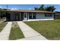 Charming single-story home featuring a well-manicured lawn, covered carport, and freshly painted exterior at 2919 Bayshore Gardens Pkwy, Bradenton, FL 34207