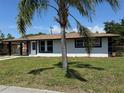 Well-maintained home with a palm tree in the front yard and freshly painted exterior at 2919 Bayshore Gardens Pkwy, Bradenton, FL 34207