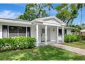 Attractive front entrance with columns and lush greenery adds to the curb appeal at 320 25Th W St, Bradenton, FL 34205