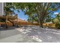 Spacious backyard featuring rock landscaping, concrete patio and wooden fence for privacy at 3356 Maiden Ln, Sarasota, FL 34231