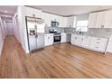 Bright kitchen featuring stainless steel appliances, white cabinets, and tile backsplash at 4501 20Th S Ave, St Petersburg, FL 33711