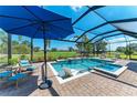Relaxing screened-in pool area with a built-in spa, sunbathing area, outdoor seating, and a view of the golf course at 4607 Benito Ct, Bradenton, FL 34211