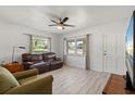 Bright living room with modern ceiling fan and laminate wood flooring at 5001 15Th N Ave, St Petersburg, FL 33710