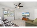 Inviting living room with large windows and laminate wood flooring at 5001 15Th N Ave, St Petersburg, FL 33710